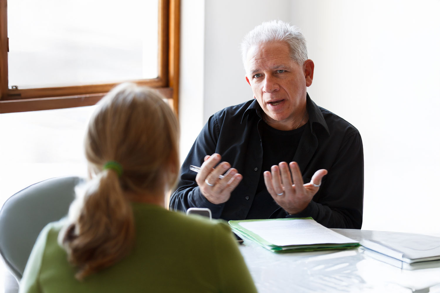 Man talking with a woman at a small table